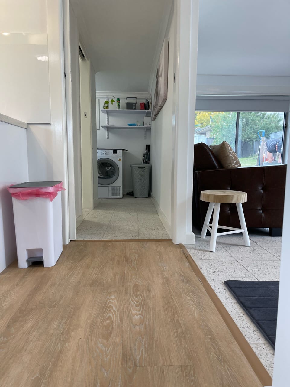 View of laundry at the end of the hallway, with the second loungeroom on right