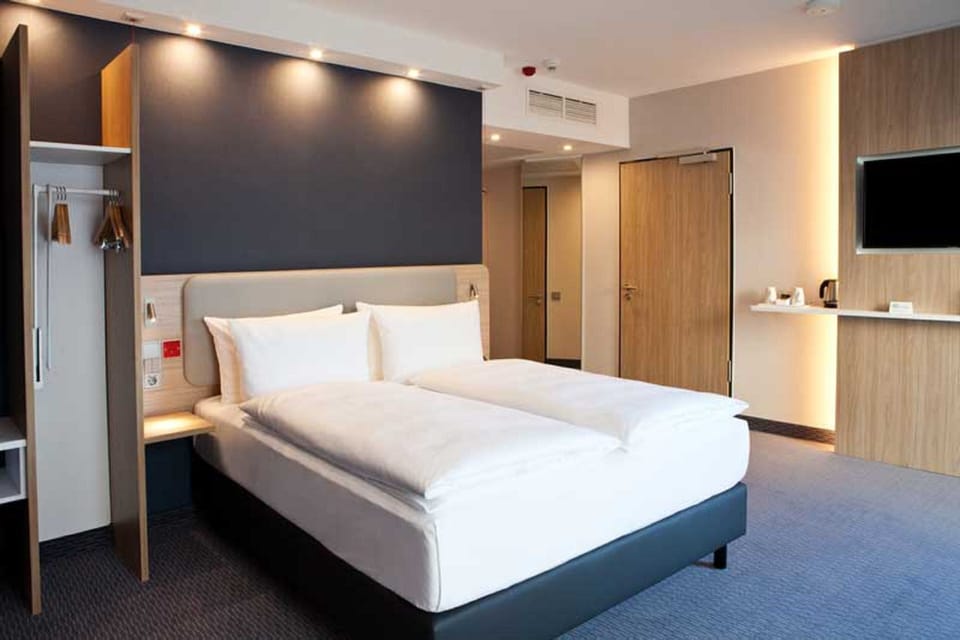 Hypo-allergenic bedding, desk, laptop workspace, blackout drapes