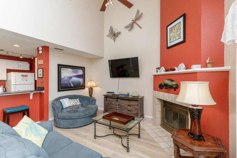 Relax in your vibrant living space with cozy seating, warm fireplace, and entertainment center for perfect evenings in.