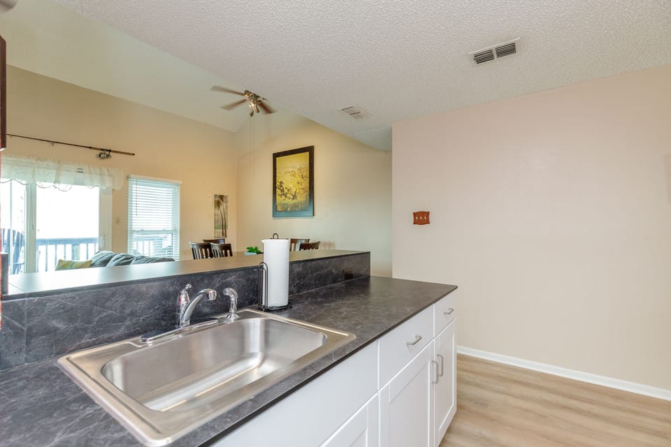 Your spacious kitchen features granite countertops, stainless steel sink, and opens to the dining area—perfect for preparing meals together.