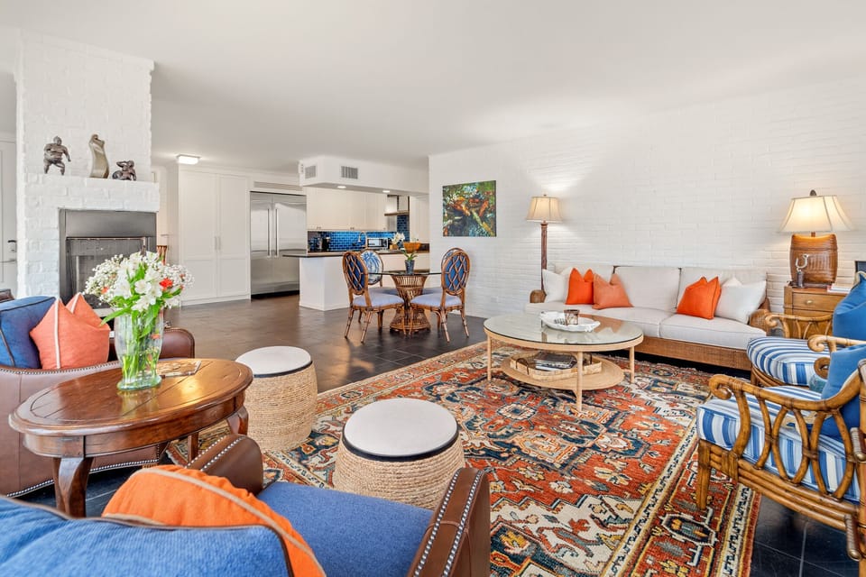 Sink into plush seating surrounded by vibrant colors and textures, where your open-concept living flows seamlessly into a chef's kitchen.