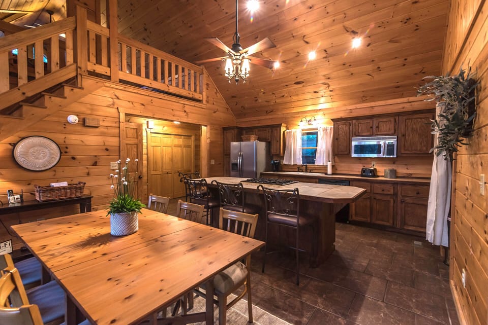 Dining room & kitchen with entry way and washer/dryer closet in background.