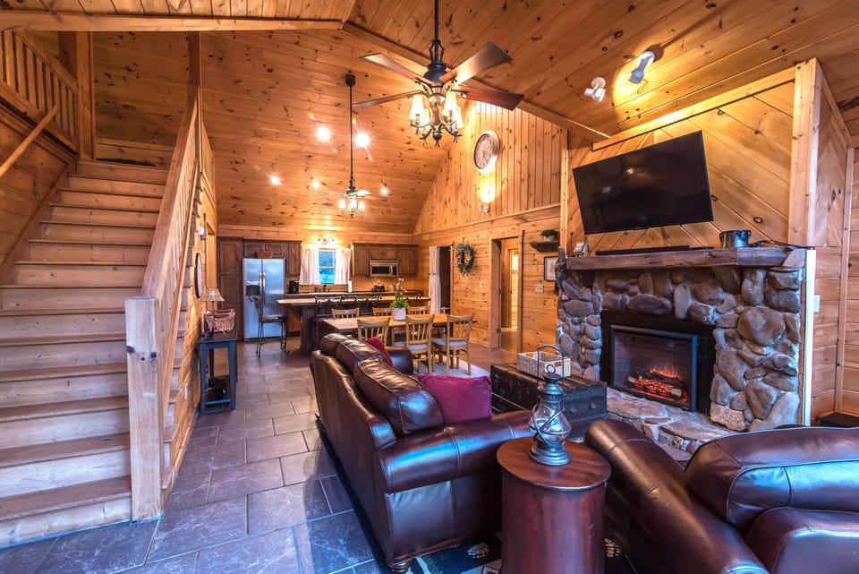 Living room with view of stairs leading to the loft and the kitchen.