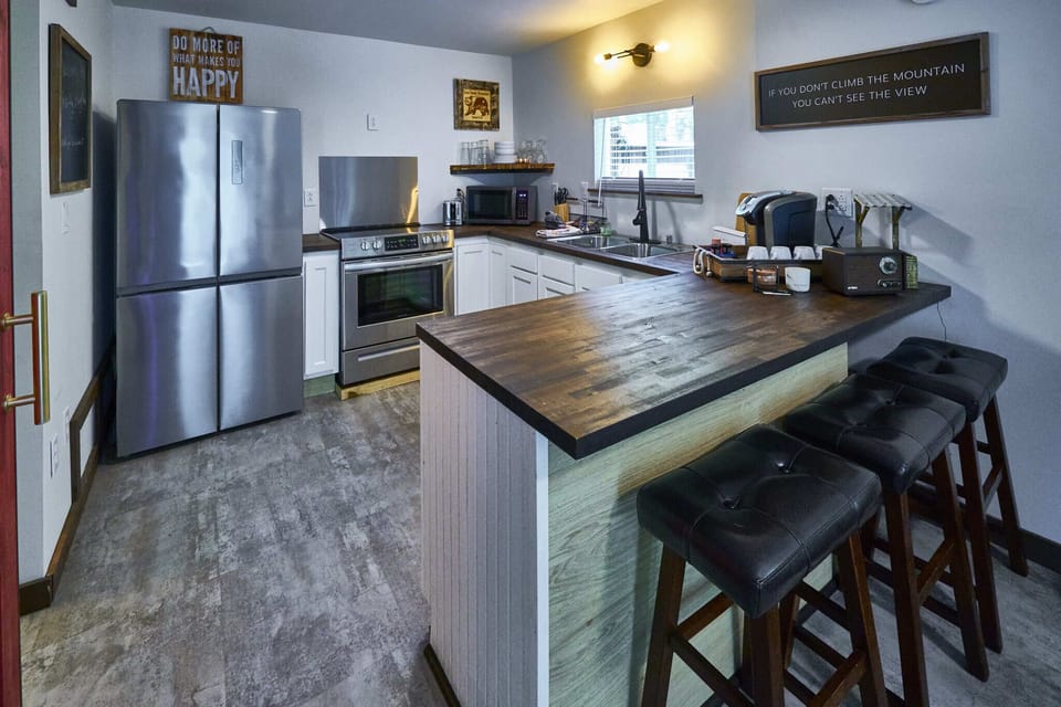 A gorgeous barnwood-style breakfast bar offers stool seating for three; the perfect spot to sip your morning coffee!