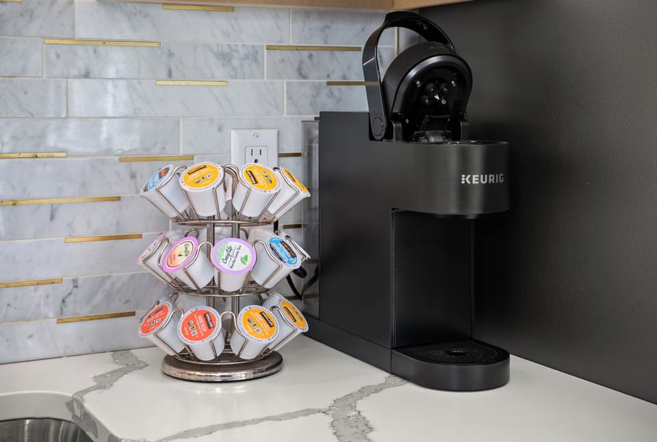 Modern Keurig coffee station with assorted pods and elegant finishes