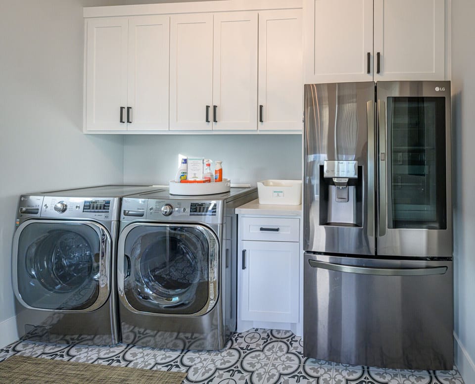 Laundry/work space with second fridge. Fridge makes crushed and round ice cubes.