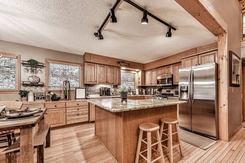 Spacious, cooking kitchen ready for your cabin experience.  Every tool is ready for your use, gas-top stove, fridge with ice maker and filtered water to utensils, pots/pans, bowls, cooking tools, spices and more.