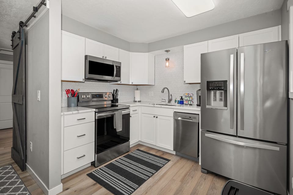Bright modern kitchen with stainless appliances and stylish finishes
