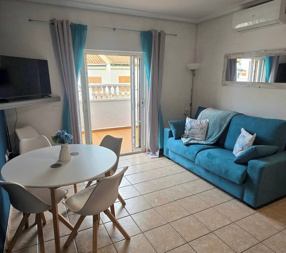 Open plan living dining room. Dining table with 5 chairs, double sofa bed