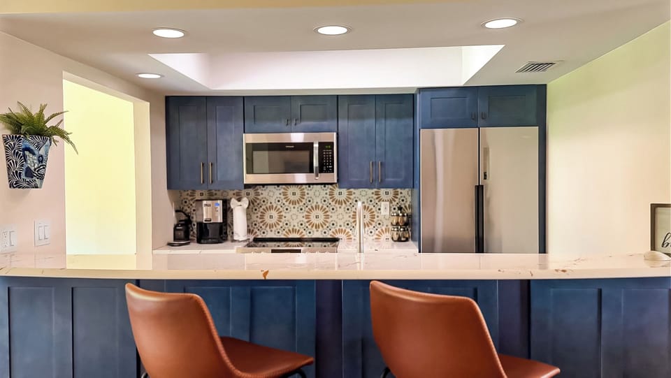 Newly renovated kitchen complete with appliances, cookware, and utensils
