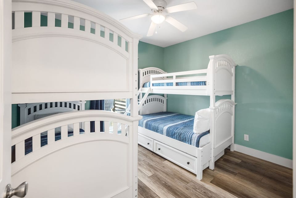Your kids will love the charming bunk beds in this cheerful bedroom, complete with coastal blue accents and plenty of space to play.
