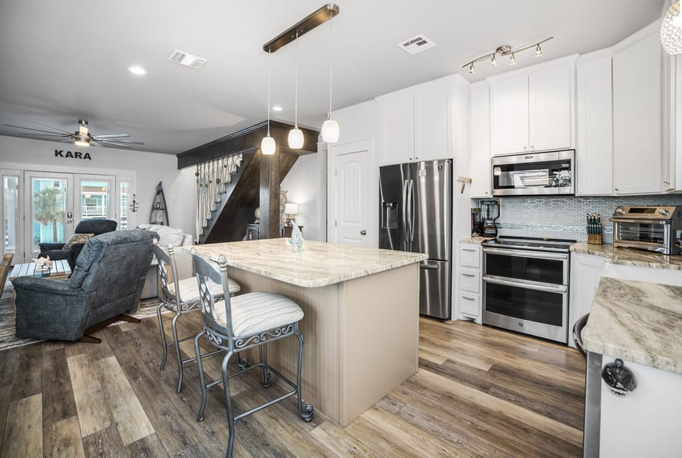 Your open-concept kitchen flows seamlessly into the living space, featuring granite countertops, stainless steel appliances, and an island perfect for morning coffee.
