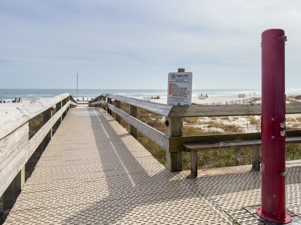 Private beach access with hoses and foot washing station.