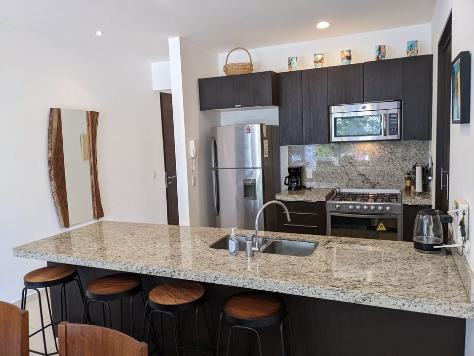 Granite counters, washer, dryer, stove, coffee maker, microwave.
