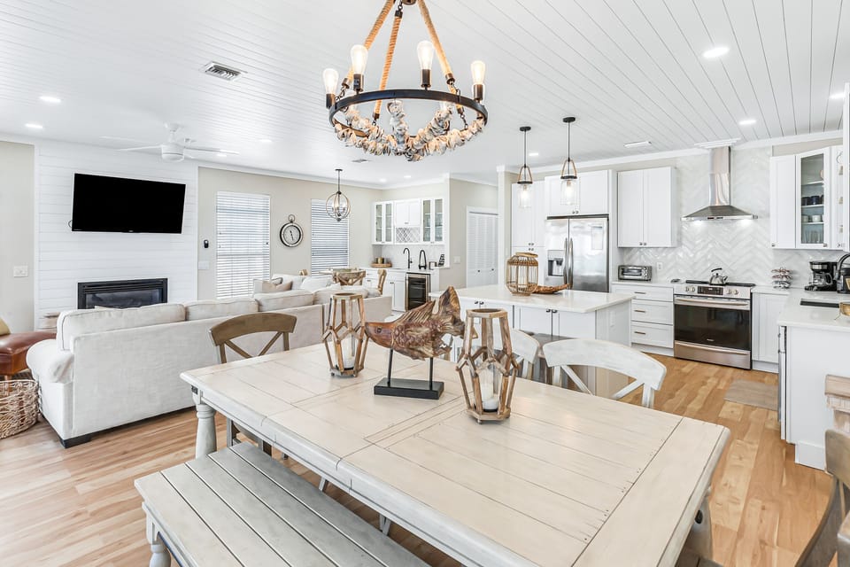 Step into your bright, open living space where coastal elegance meets modern comfort—perfect for cooking, dining, and relaxing together.