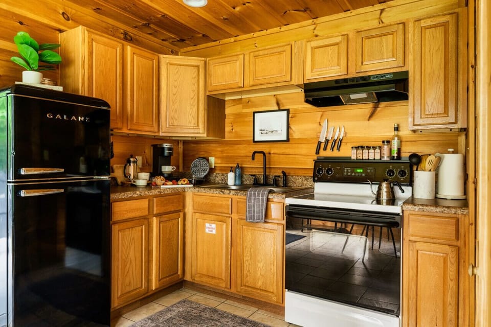 Kitchen: Whip up culinary delights in this stylish cabin kitchen, featuring modern appliances and charm!