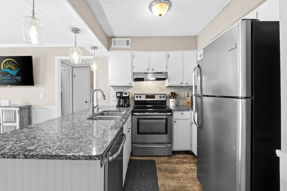 Functional and inviting kitchen with full amenities and casual bar seating.