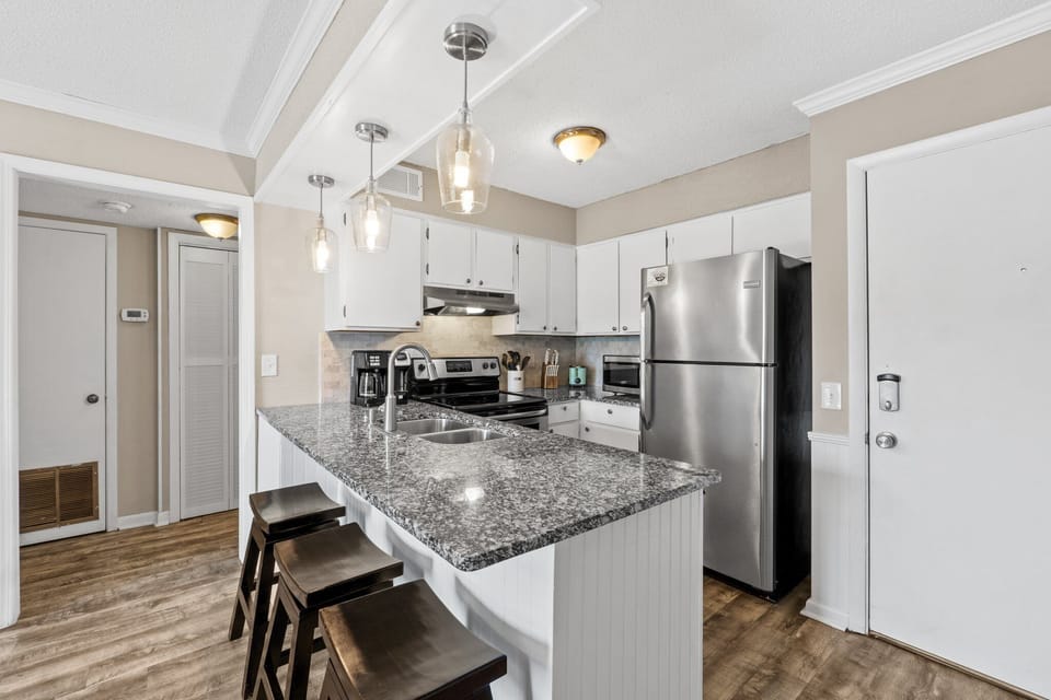 Functional and inviting kitchen with full amenities and casual bar seating.