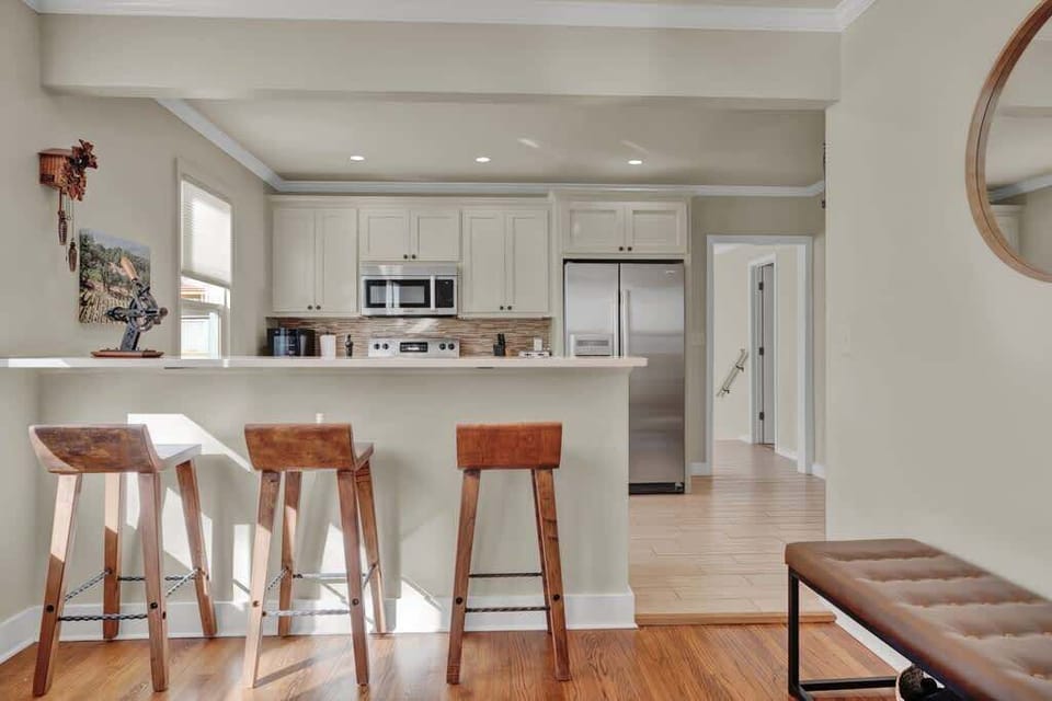 Kitchen island with bar seating, plus additional dining space nearby for group meals.