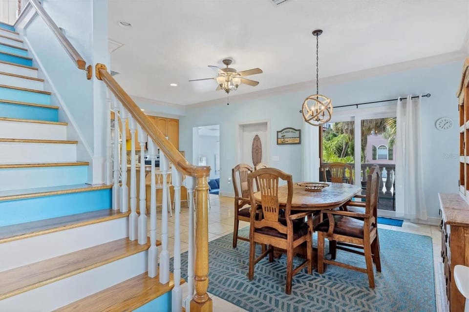 Grand staircase with chandelier and view down to the dining area
