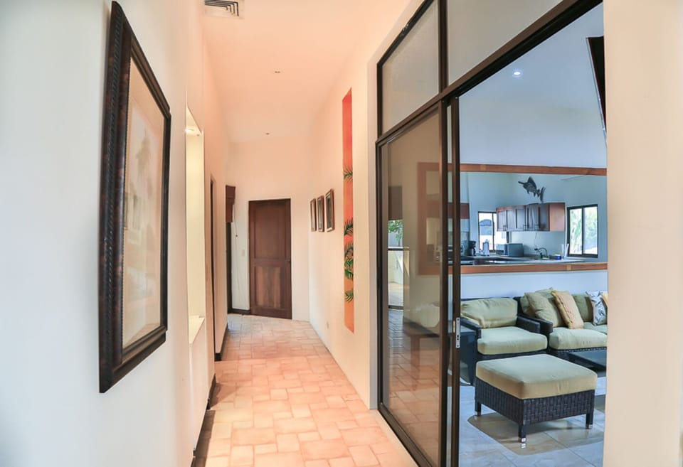 Hallway to the bedrooms and outside balcony./