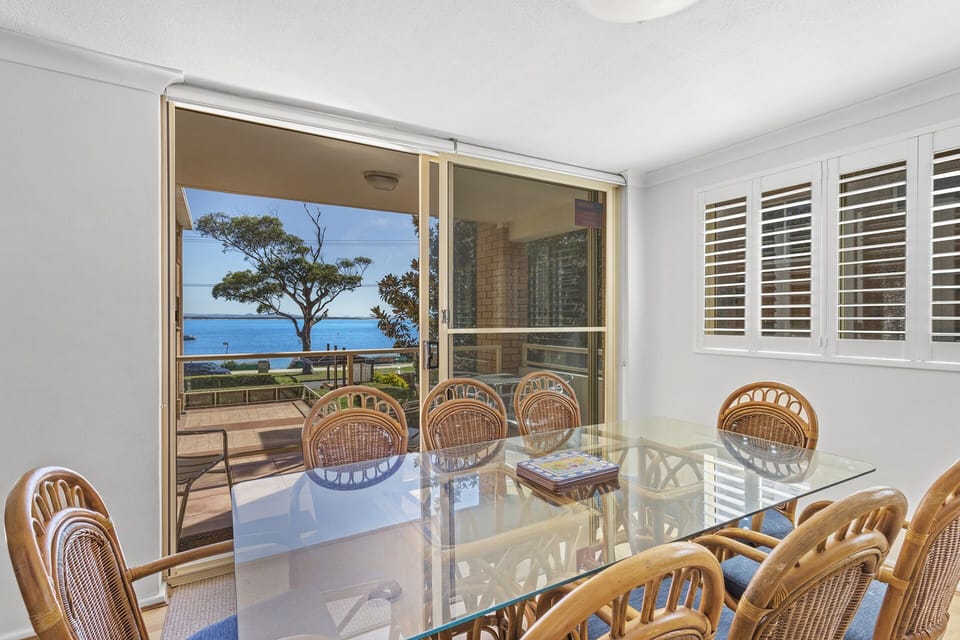 Dining table adjacent to kitchen. 