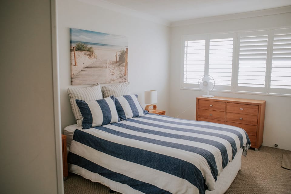 Main bedroom with queen bed, ensuite and private balcony.