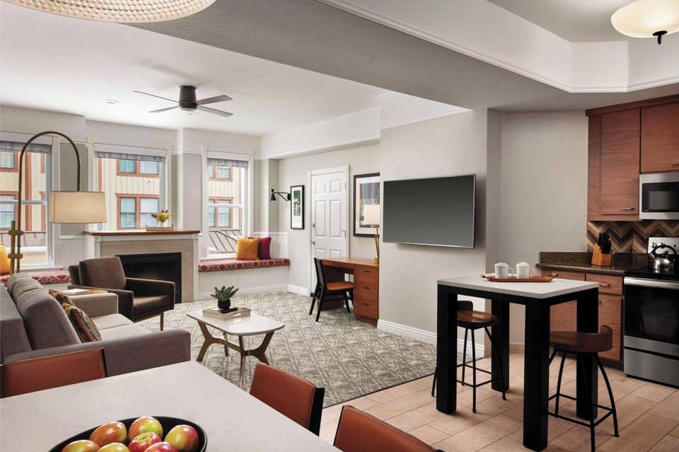 Spacious condo with large dining table and additional high top seating.