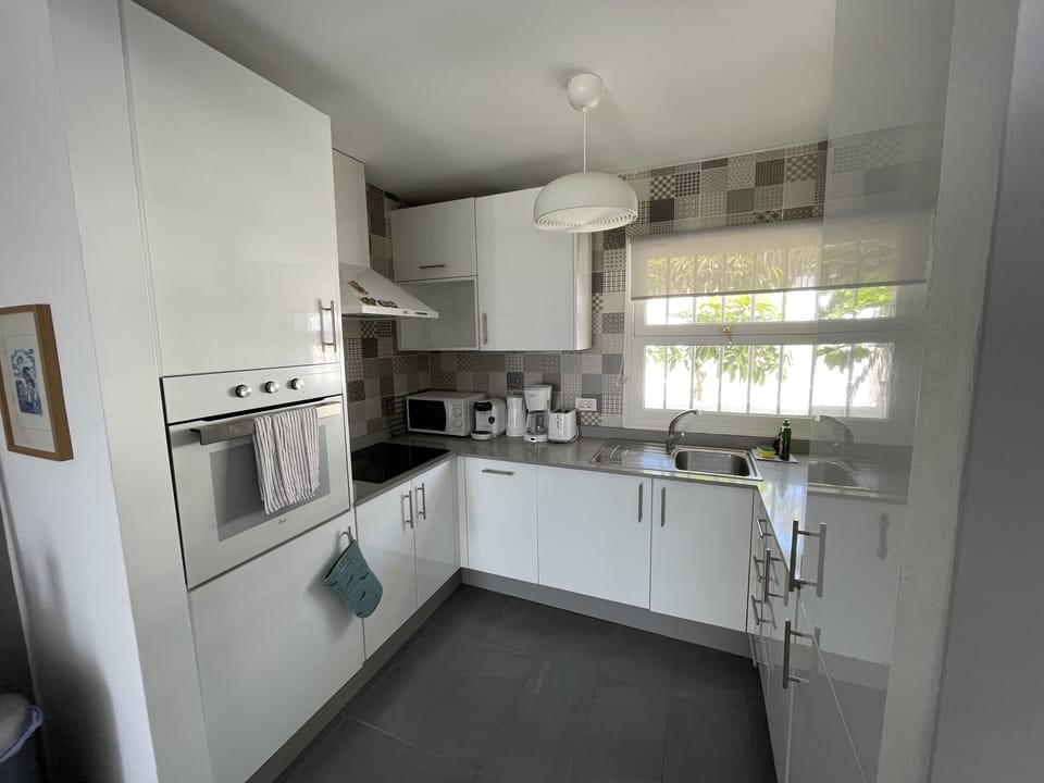 Range of appliances and kitchen equipment provided. 