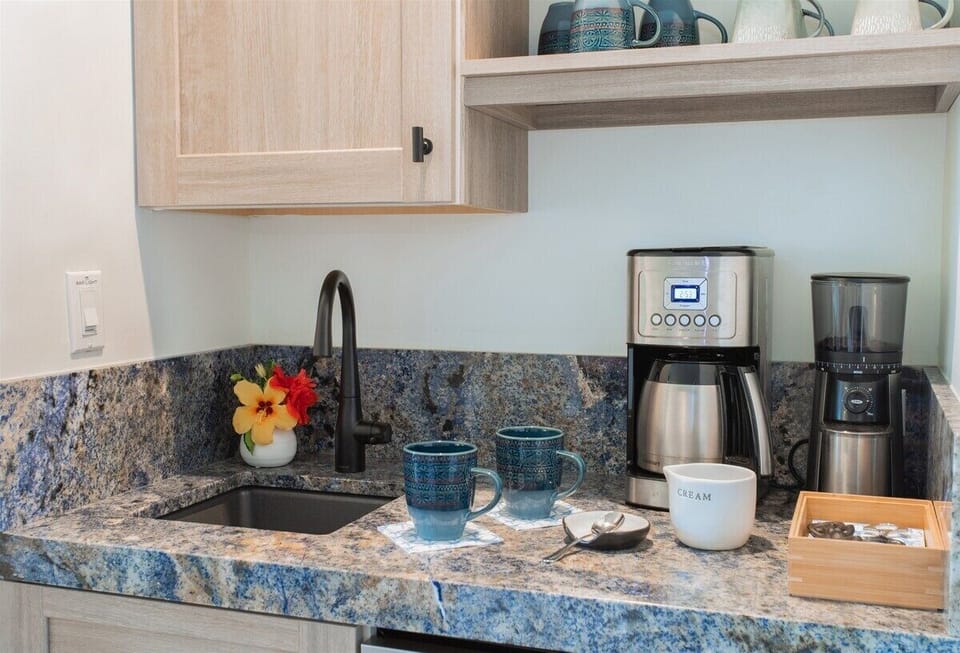 The coffee bar offers a coffee grinder, 14 cup coffee maker and the added bonus of a sink with a water purifier