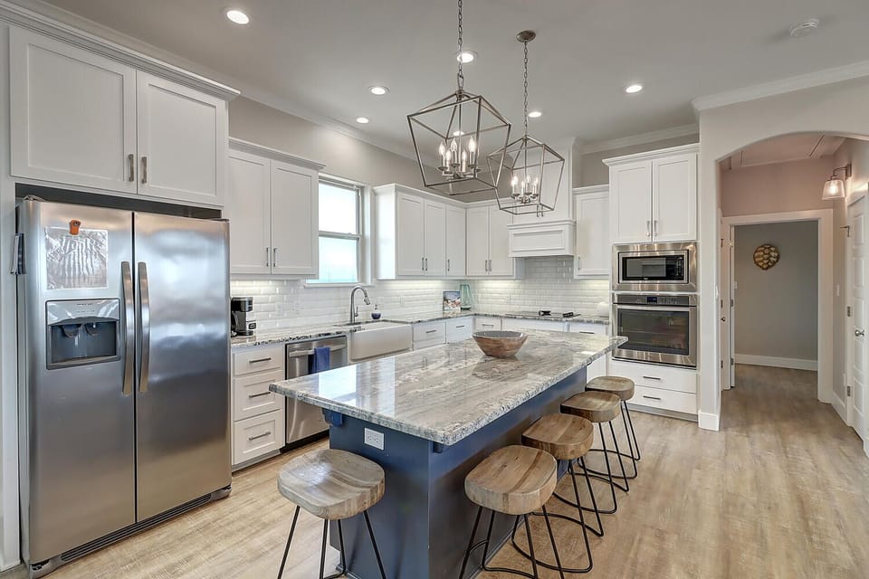 Cook your favorite meals in this stunning kitchen with granite counters, modern appliances, and plenty of space to gather.