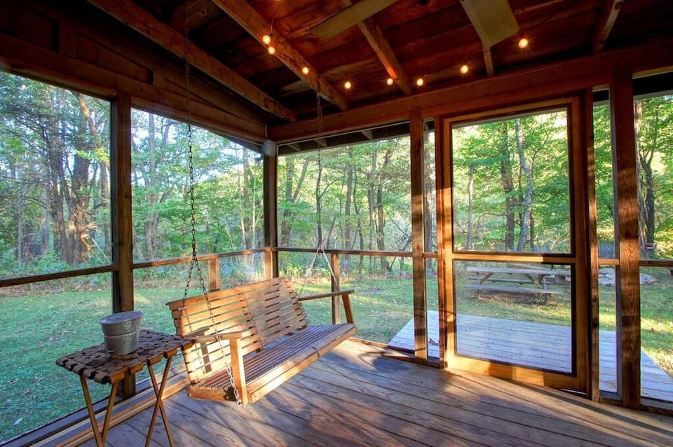 Inside view of our screened-in porch overlooking the firepit!