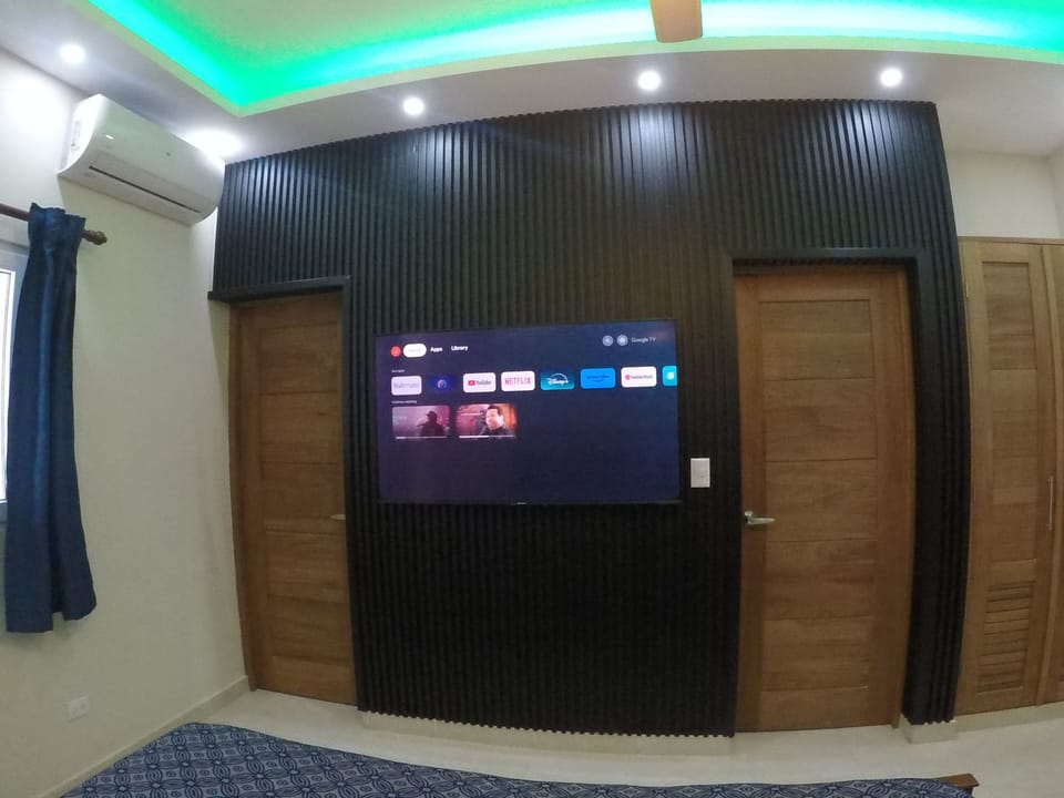 The The 55inch tv with 100meg internet. The left door goes to the bathroom.