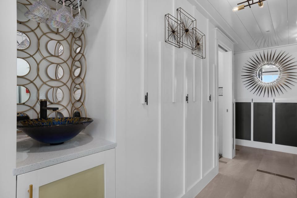 Step into your stylish entryway where modern art meets coastal elegance, setting the perfect tone for your beachside retreat.