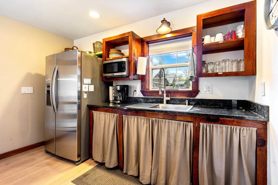 Fully equipped kitchen with drip coffee maker and large fridge