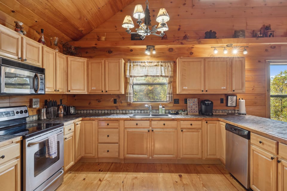 Spacious kitchen with stainless steel appliances and real oak cabinets.