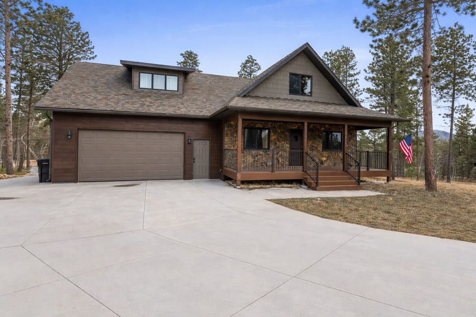 Spacious Black Hills cabin with garage and large driveway parking.