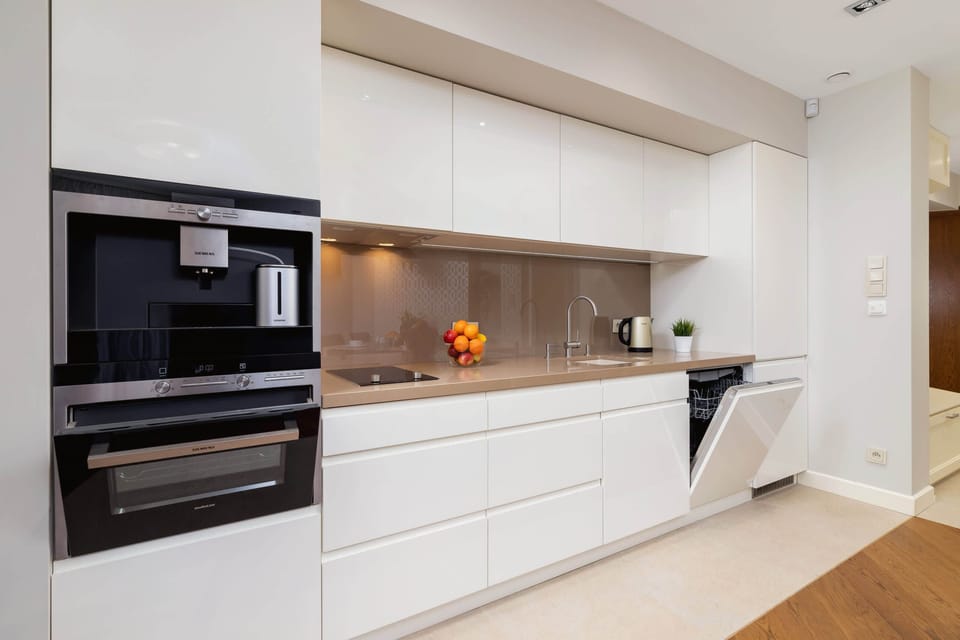 Kitchenette with oven and refrigerator. 