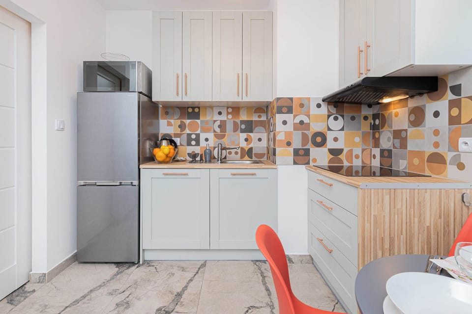Fully equipped kitchenette with a kettle, induction hob, fridge freezer, dishwasher and microwave.