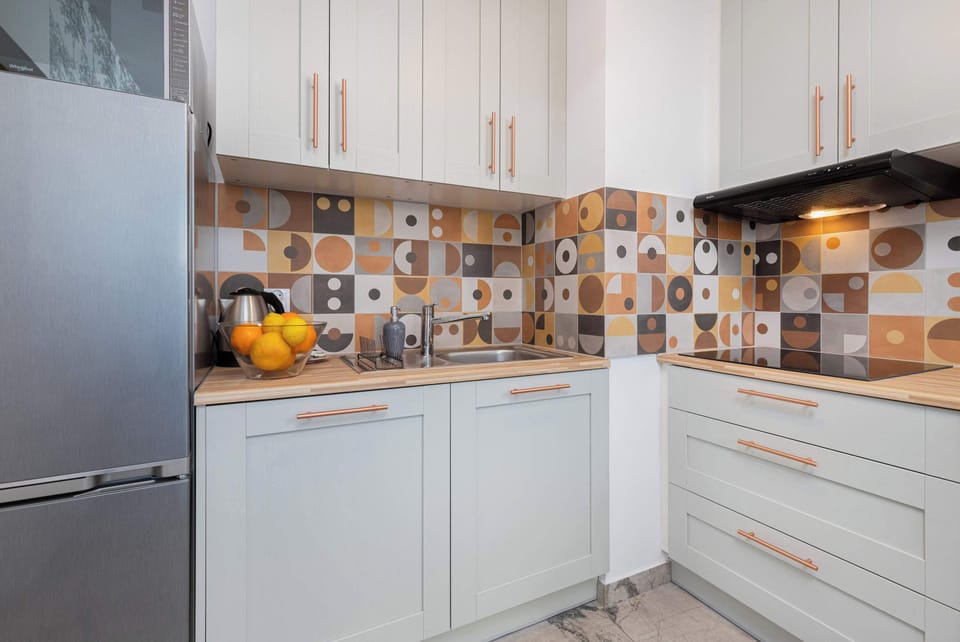 Kitchenette with a kettle, induction hob, fridge freezer, dishwasher and microwave.