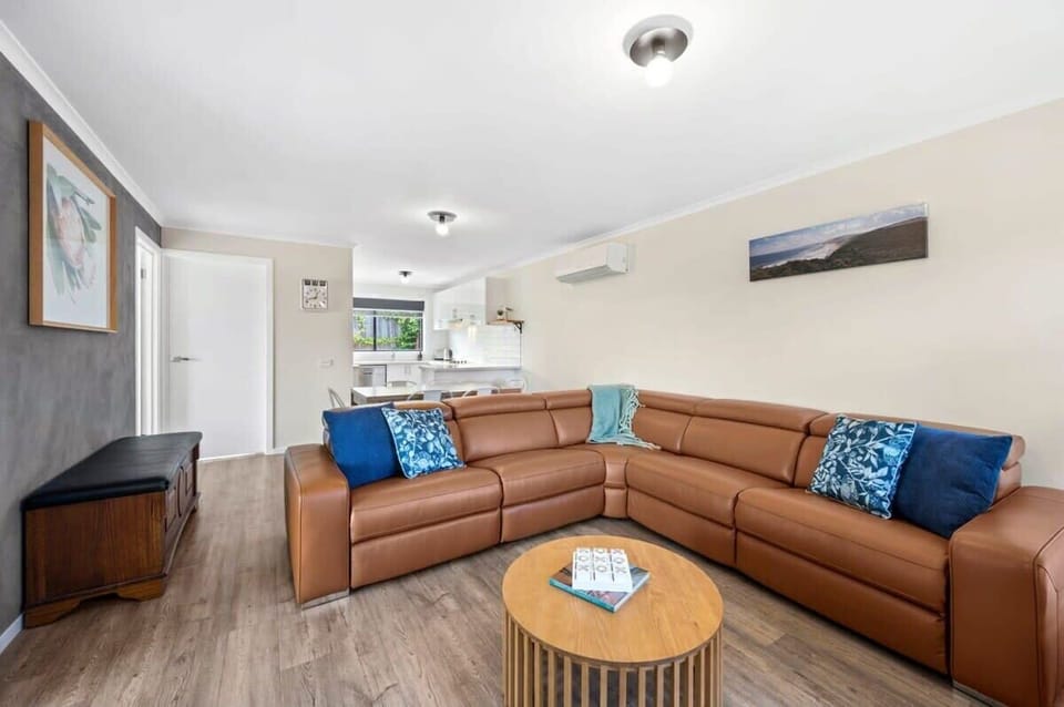 The spacious living area features plenty of natural light, comfortable seating, and a split system A/C 