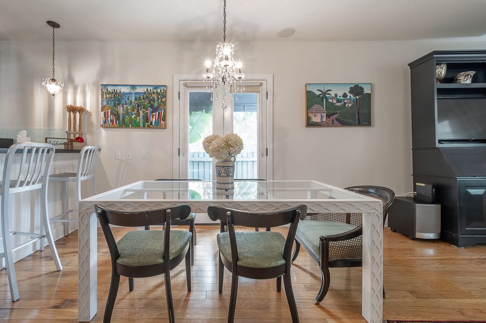 Dining room table w/ 5 chairs off living room. 