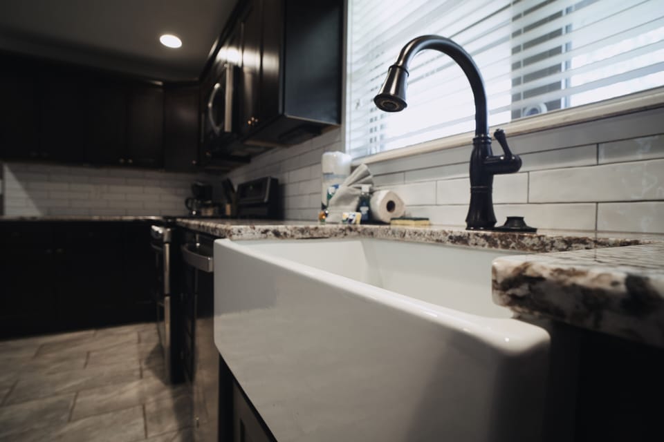 Kitchen with stainless steel appliances, farm sink, and cooking essentials.