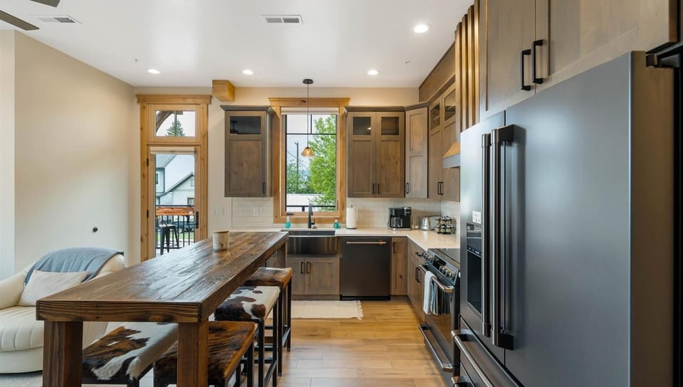 Fully stocked kitchen with top of the line appliances, breakfast bar seating for 6, and convection stove top.