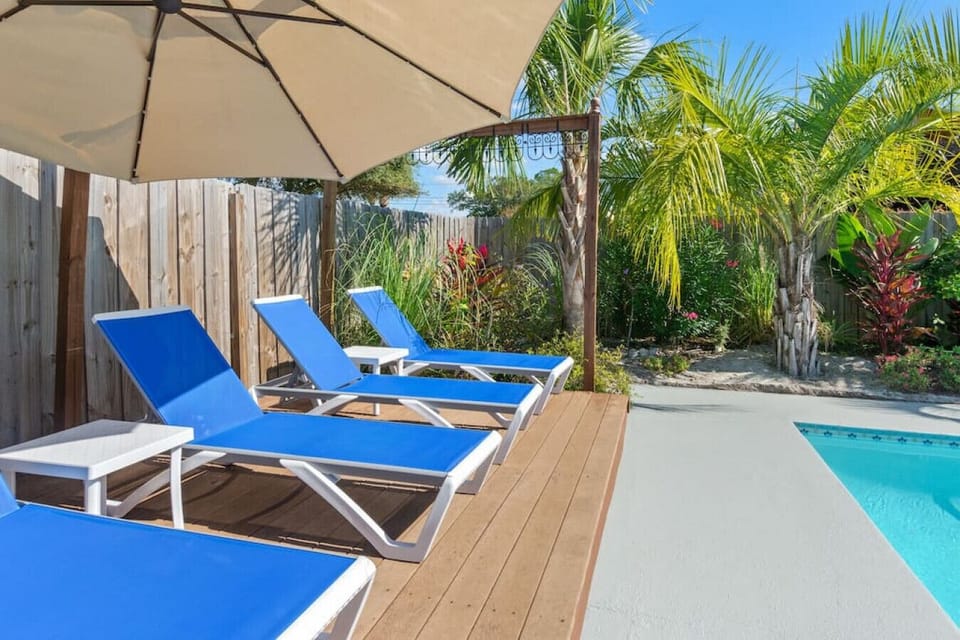 Relax by the pool on comfortable loungers with a shaded umbrella for ultimate comfort.