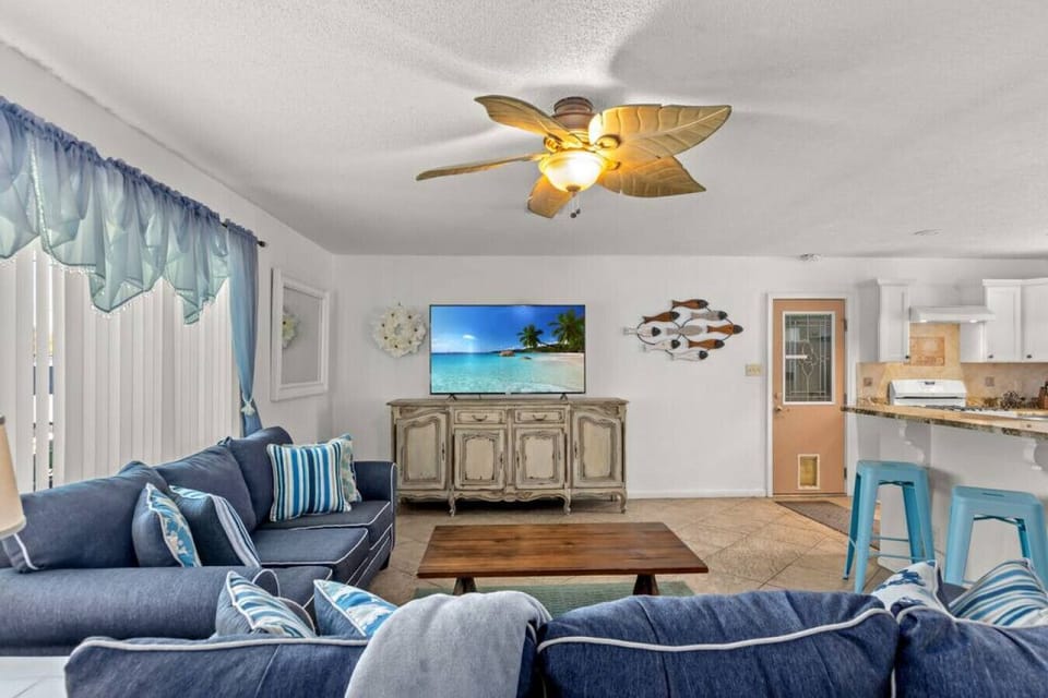Bright and airy open living space seamlessly connecting the kitchen and dining area, featuring a pull-out sofa for 2 guests.