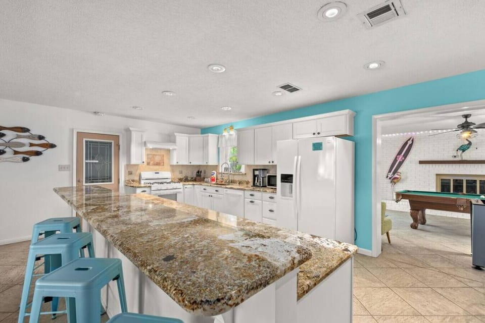 Enjoy a fully stocked, open kitchen with granite countertops, a breakfast bar, and a gas range—perfect for whipping up anything from quick breakfasts to gourmet meals.