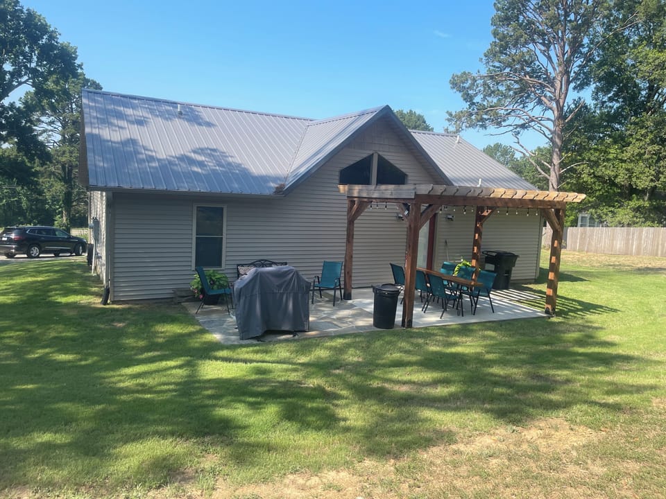 Large backyard with fire pit and outdoor games 