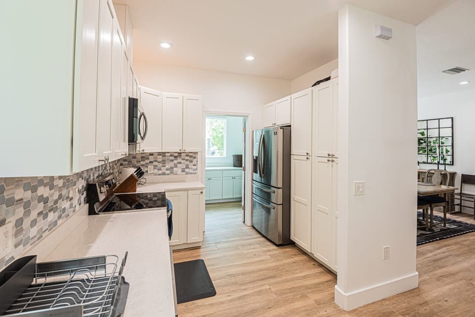Fully stocked kitchen with access to laundry room area