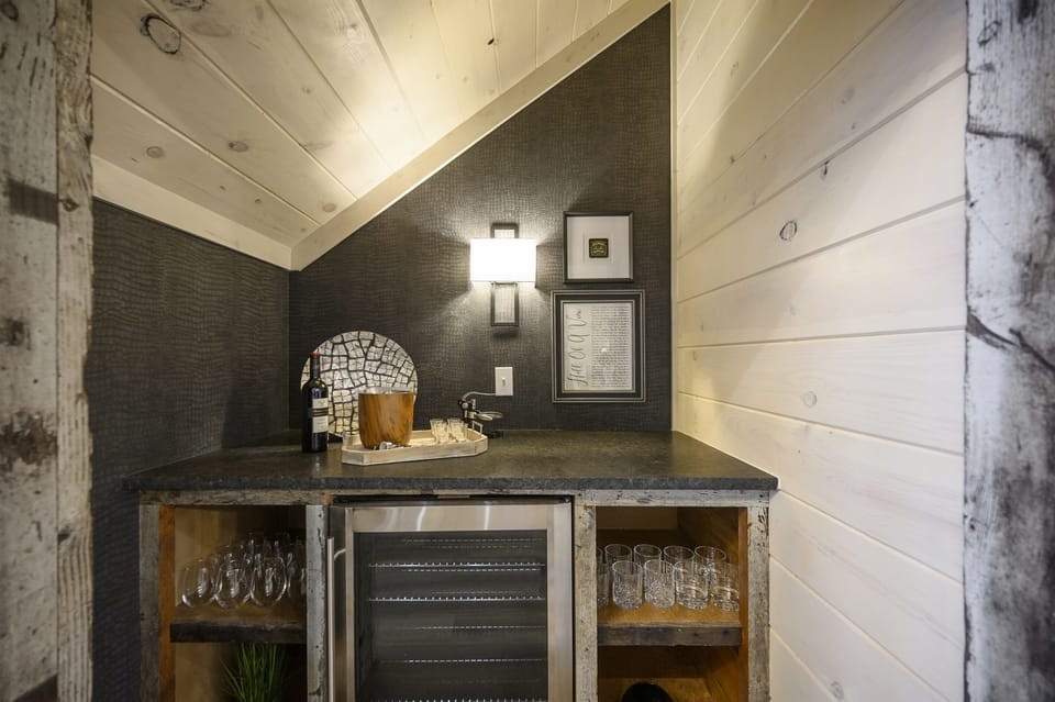 Mix and enjoy cocktails from the bar with mini-fridge built into the staircase. 